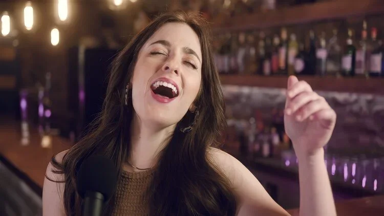 Emily singing in a bar setting